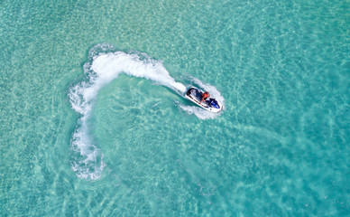 People are playing a jet ski in the sea.Aerial view. Top view.amazing nature background.The color...