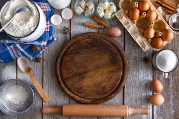 Baking ingredients on rustic wood background