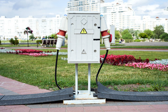 Switchboard high voltage with connected cables on a street.