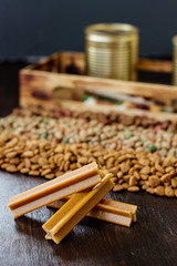 Dry pet food on black wooden table.