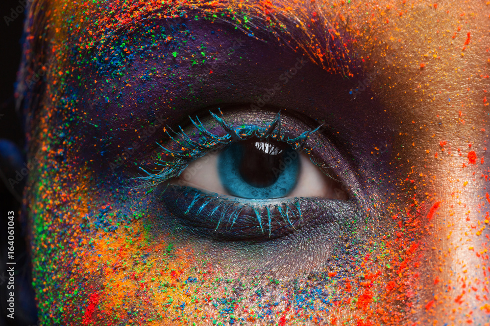 Wall mural eye of model with colorful art make-up, close-up
