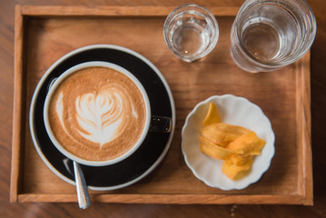 Cup coffee and set food and drink on wooden table in coffee shop at morning  .