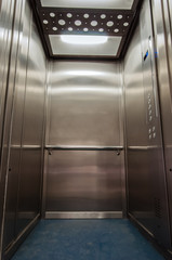 Elevator with new and modern cabin made of bright alloy and metal with modern elevator buttons © Toshe