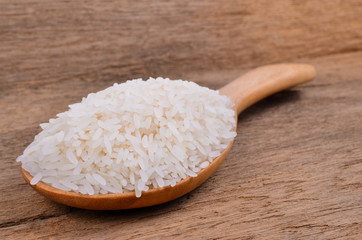 Rice with wooden spoon on wooden