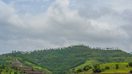 Naklejka premium The Lush Green Mountains and Beautiful Muddy Lake of Panshet, Maharashtra, India