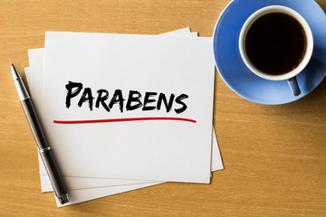 Parabens (Happy Birthday in Portuguese) - handwriting on papers with cup of coffee and pen, concept