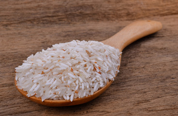 Rice on a wooden spoon on a wooden