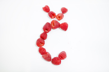 Alphabetical letter Č made of raspberries on a white background