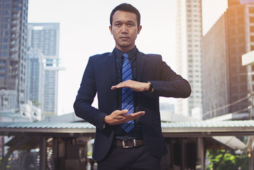 Businessman in a suit and tie with outstretched hand for implementation of graphic. Concept: Your objects are here