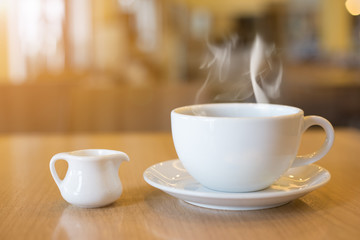 Cup of coffee and smoke on wooden floor