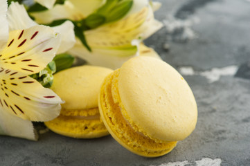 Arrangement of lily flowers, yellow macaroons