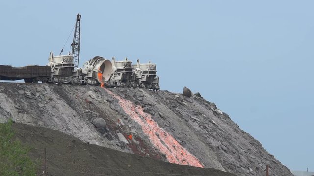 Pour molten slag from the diesel locomotive tank at a metallurgical plant. Slow motion