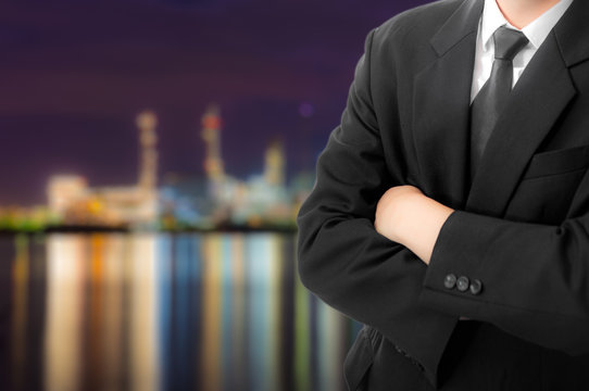 Power plant and oil tank, petrochemical industrial plant at night and Twilight sky view, technician Industrial workers, engineer manager working in a power plant. Businessman.