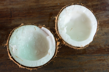 Fototapeta na wymiar Coconut milk splited on wooden table