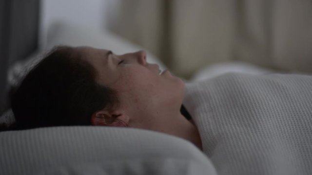 Woman snoring in bed