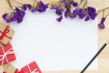 purple dry flowers and presents on white paper with pencil