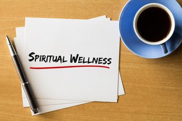 Spiritual wellness - handwriting on papers with cup of coffee and pen, health concept