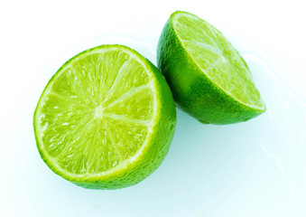 Sliced ripe juicy lime on white