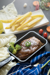 Fresh grilled meat. Grilled beef steak In the pan, French fries and Mashed potato with spoon, in serving bowl