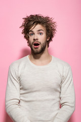 surprised man with long uncombed hair wake up in morning