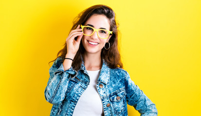 Fototapeta premium Happy young woman on a yellow background