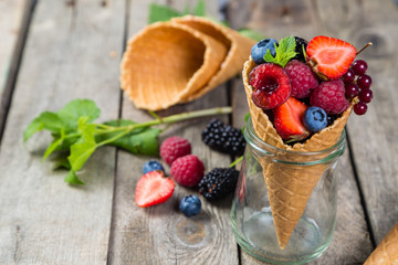 Selection of berries in ice cream cones - healthy dessert concept