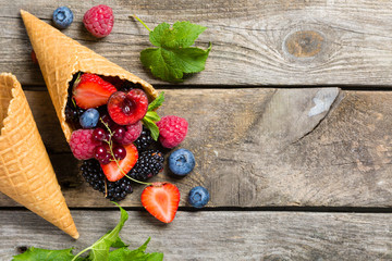 Selection of berries in ice cream cones - healthy dessert concept