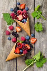 Selection of berries in ice cream cones - healthy dessert concept