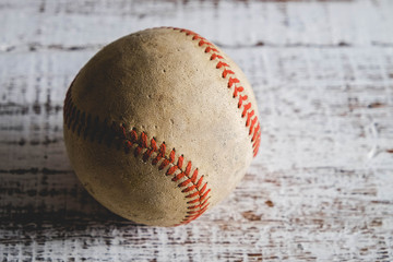old Baseball and glove on wood background with filter effect retro vintage style