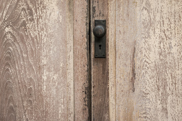 Rustic vintage door knob on antique door wood. Door knob and keyhole made of brass on the old wooden door. Door knob for background.
