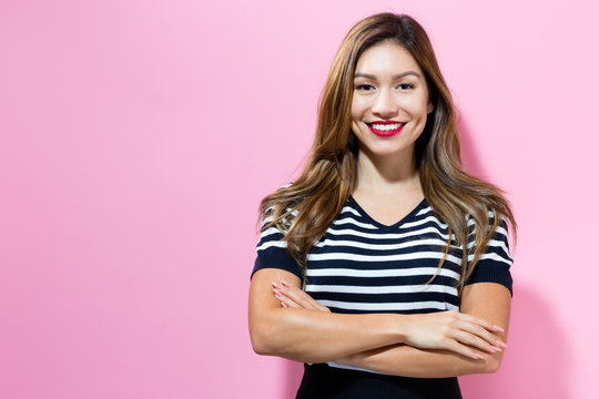 Happy young woman on a pink background