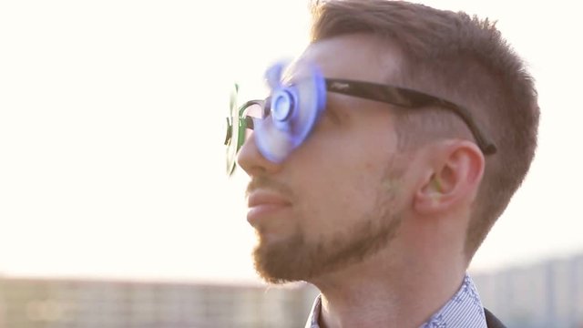 younge man with the spinner glasses