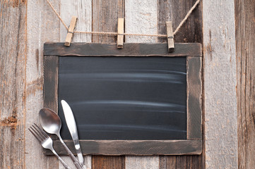 Menu blackboard with fork on  wooden background