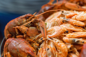 Seafood, tasty boiled crawfish and shrimp on the restaurant table. Selective focus.