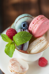 Assorted colofrul macarons with fresh berries