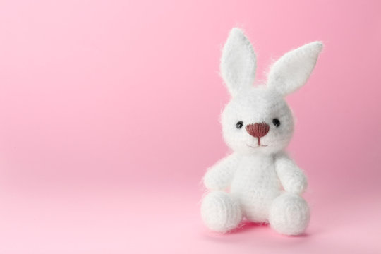 Cute handmade bunny toy on color background, closeup