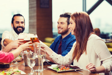 friends dining and drinking beer at restaurant