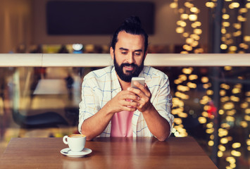 happy man with smartphone and coffee at restaurant