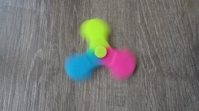 Playing with the colorful Fidget Spinner. Toy spinner.