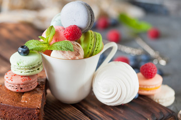 Assorted colofrul macarons with fresh berries