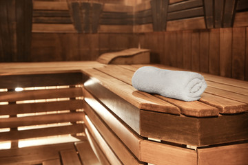 Fototapeta na wymiar Towel on wooden bench in sauna