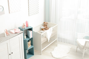 Modern interior design of baby room with crib