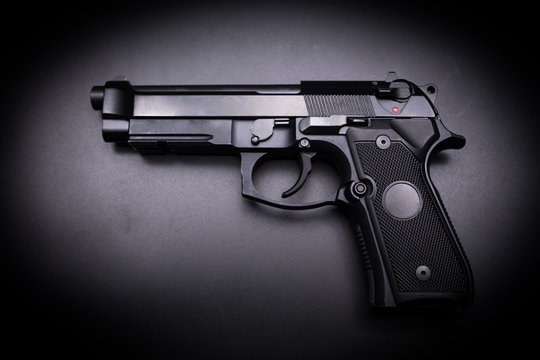  9mm pistol gun on black background