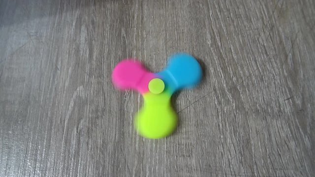 Playing with the colorful Fidget Spinner. Toy spinner.