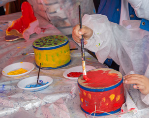 Children decorating handmade drum