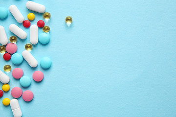Different pills on color background