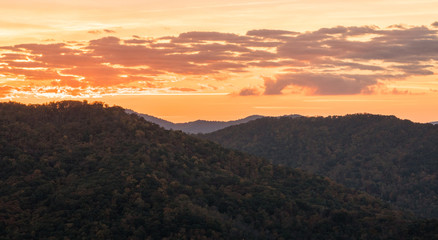 orange moorig sky at daybreak over the rolling hills and mountains of the North Carolina Appalachians in the fall