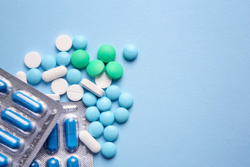 Different pills on color background