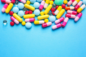 Different pills on color background