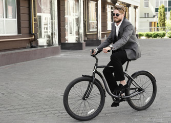 Fototapeta premium Young man riding bicycle outdoors